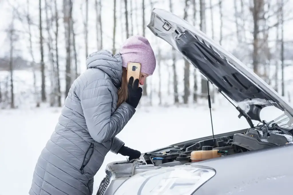 beautiful tense woman stands road waits help broken car with hood open energy2store