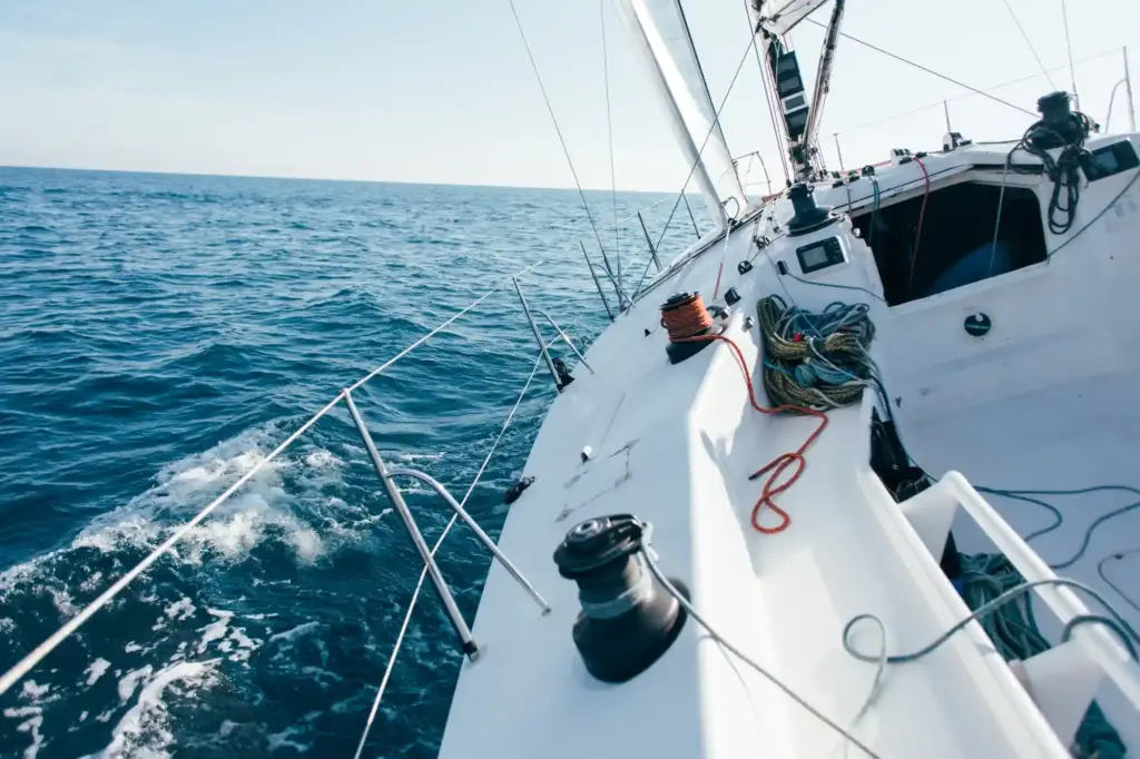 deck professional sailboat racing yacht during competition sunny windy summer day moving fast through waves water with spinnaker up galerija e2s