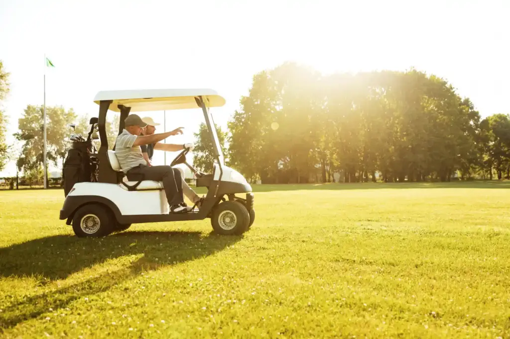 two male golfers driving golf cart galerija e2s